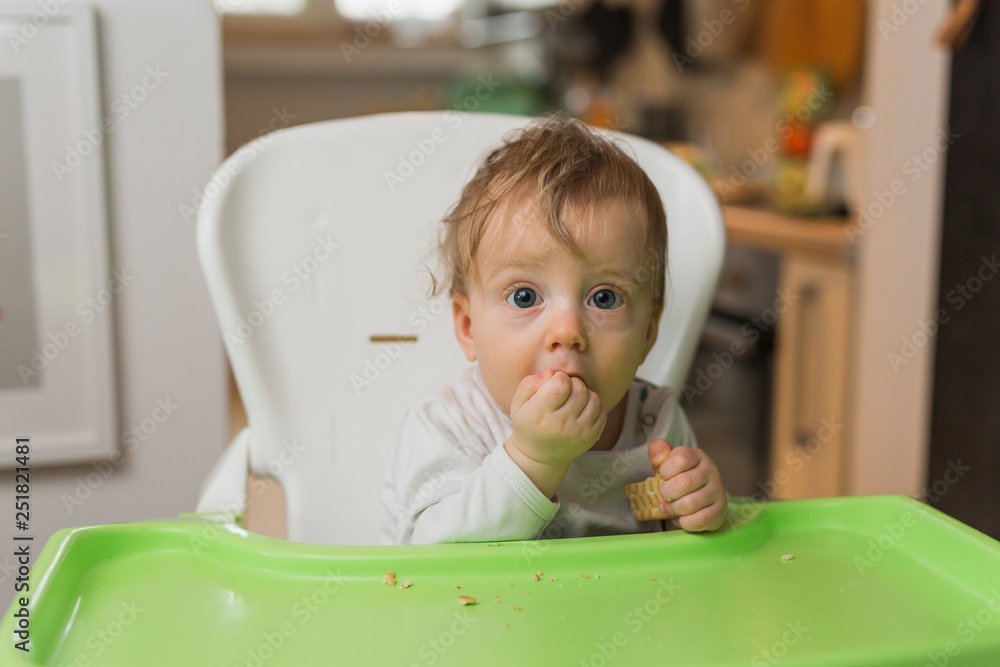 little baby boy eats biscuits and looking at camera little baby boy eats biscuits and looking at camera