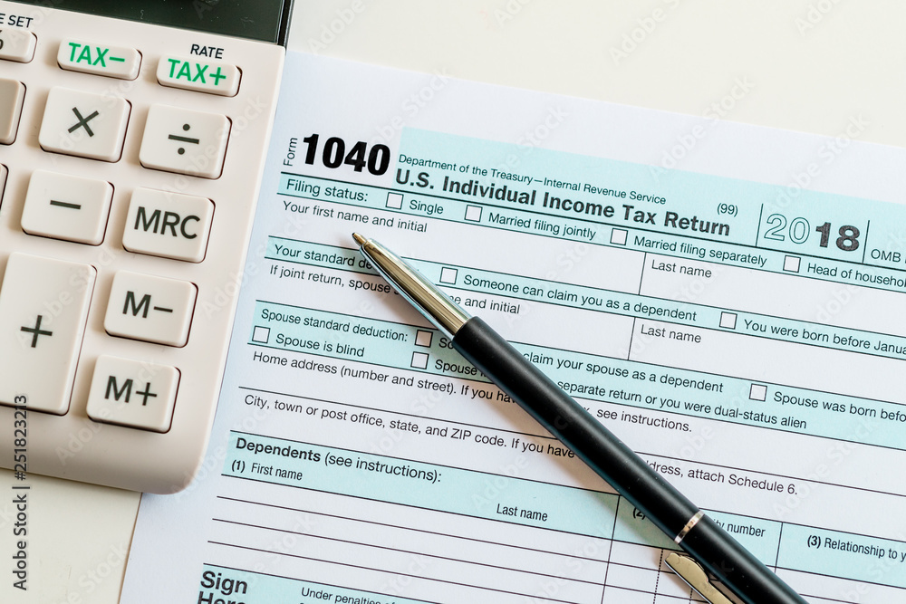 New 2019 IRS 1040 tax form, instructions, pen and calculator New 2019 IRS 1040 tax form, instructions, pen and calculator