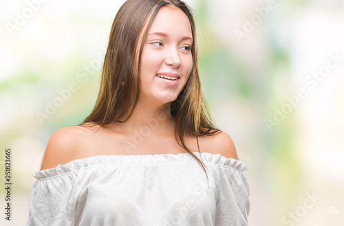 Young caucasian beautiful woman over isolated background looking away to side with smile on face, natural expression. Laughing confident.