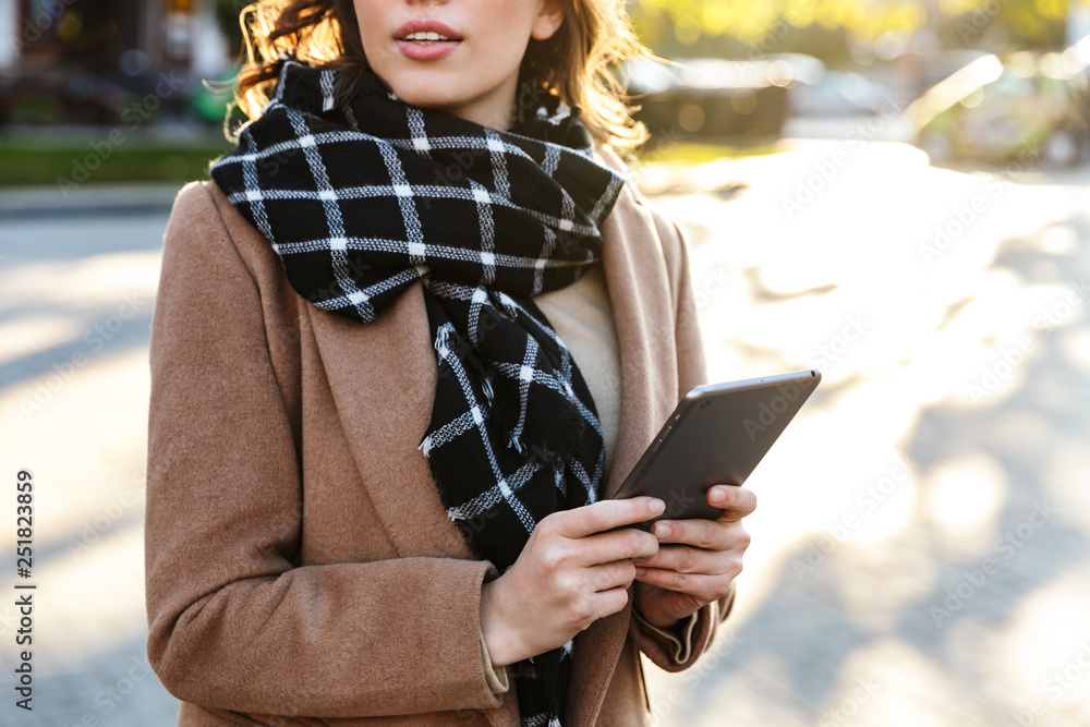 Fototapeta premium Cropped photo of a beautiful young woman using tablet computer.