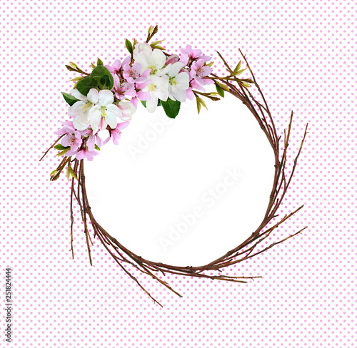 Round wreath from dry twigs with spring branches of peach and apple flowers