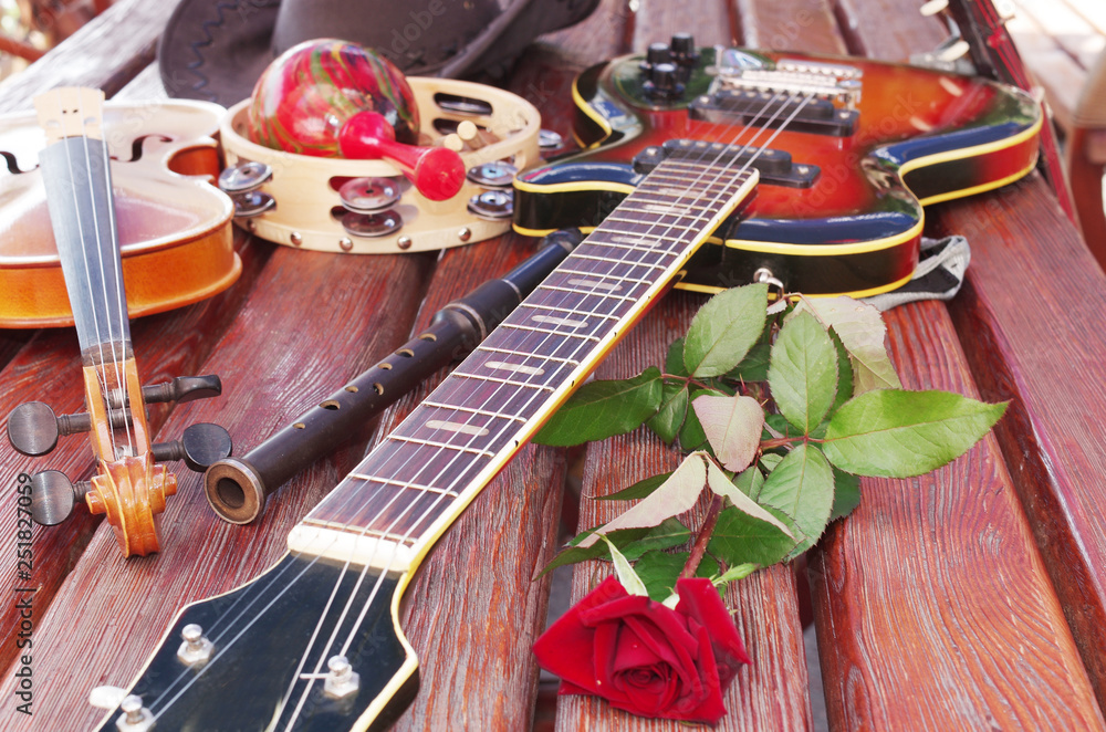 Electric guitar, flute, maracas, tambourine, red rose Stock Photo | Adobe  Stock
