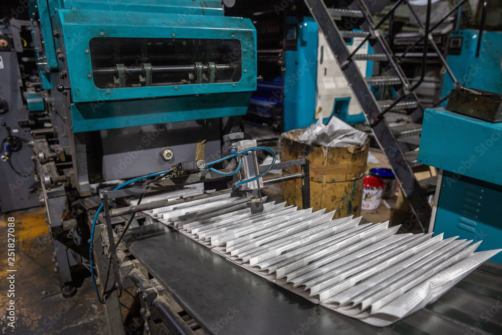 newspaper printing equipment in a dark room