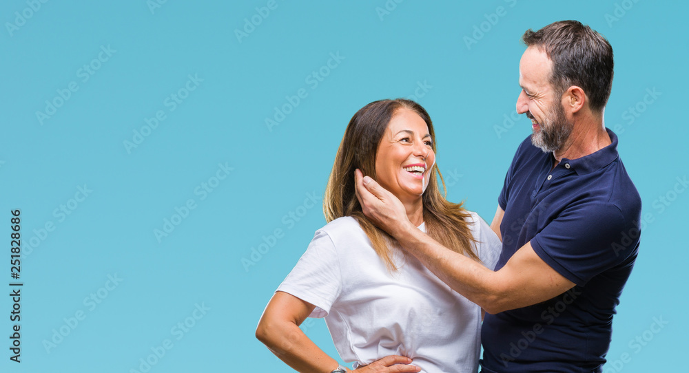 Middle age hispanic casual couple over isolated background happy face smiling with crossed arms looking at the camera. Positive person. Middle age hispanic casual couple over isolated background happy face smiling with crossed arms looking at the camera. Positive person.