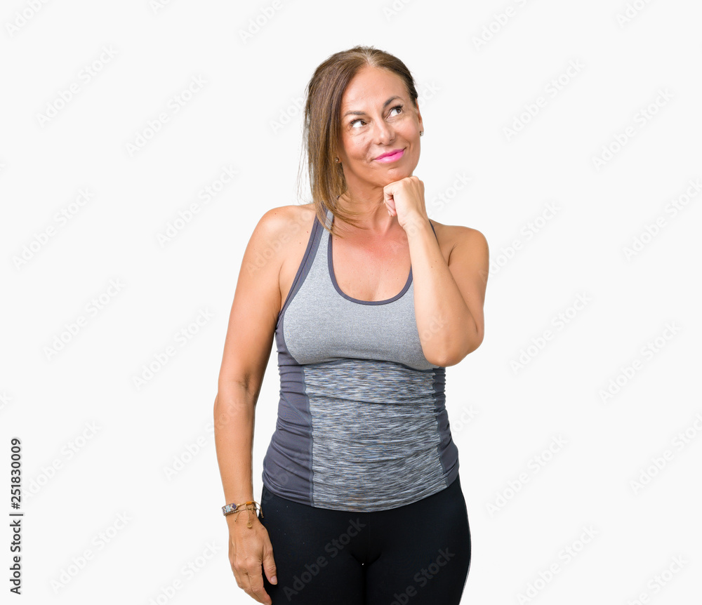Beautiful middle age woman wearing sport clothes over isolated background with hand on chin thinking about question, pensive expression. Smiling with thoughtful face. Doubt concept. Beautiful middle age woman wearing sport clothes over isolated background with hand on chin thinking about question, pensive expression. Smiling with thoughtful face. Doubt concept.