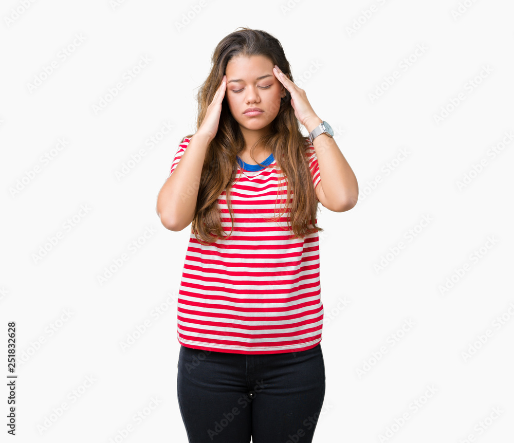 Young beautiful brunette woman wearing stripes t-shirt over isolated background with hand on head for pain in head because stress. Suffering migraine. Young beautiful brunette woman wearing stripes t-shirt over isolated background with hand on head for pain in head because stress. Suffering migraine.