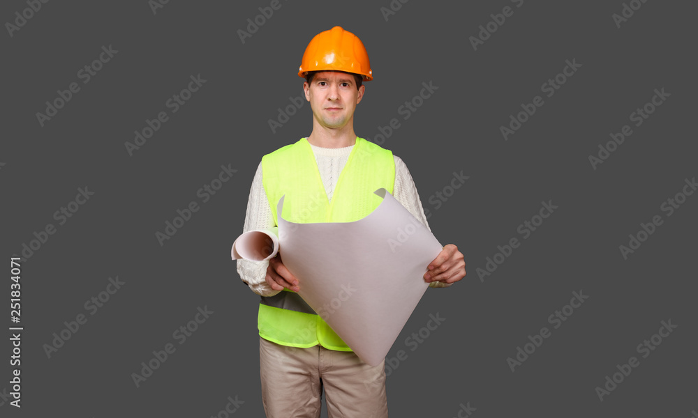 the civil engineer in a helmet looks at drawings the civil engineer in a helmet looks at drawings