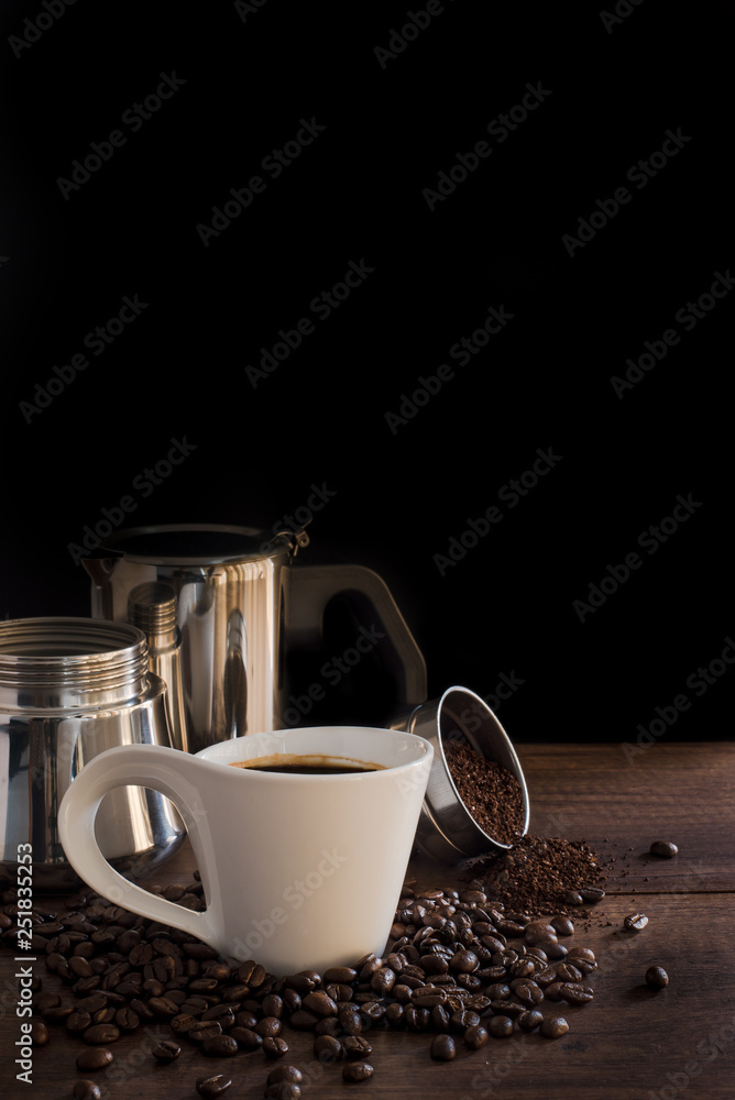 Stainless Steel moka pot and coffee beans on wooden table Stainless Steel moka pot and coffee beans on wooden table