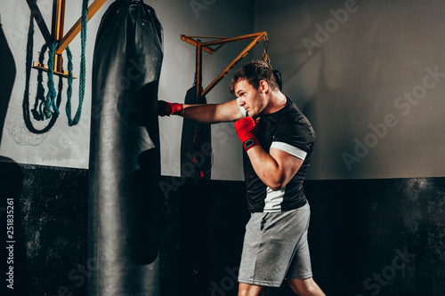 Fighter man training in heavy bag at gym © kleberpicui