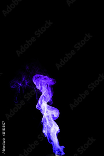 Dual colour vape steam column with spray boiling liquid. Blue and purple colour smoke. Stock photo isolated on black background.