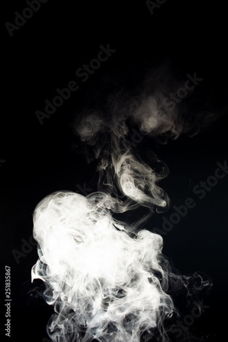 Vape steam spread with spray boiling liquid. Stock photo isolated on black background. Vape culture outreach. Conceptual image. © Alexs