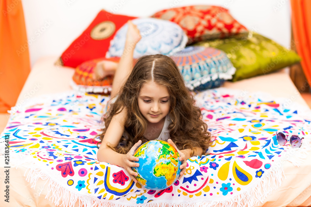 Little Girl with a globe in the arabic interior Little Girl with a globe in the arabic interior
