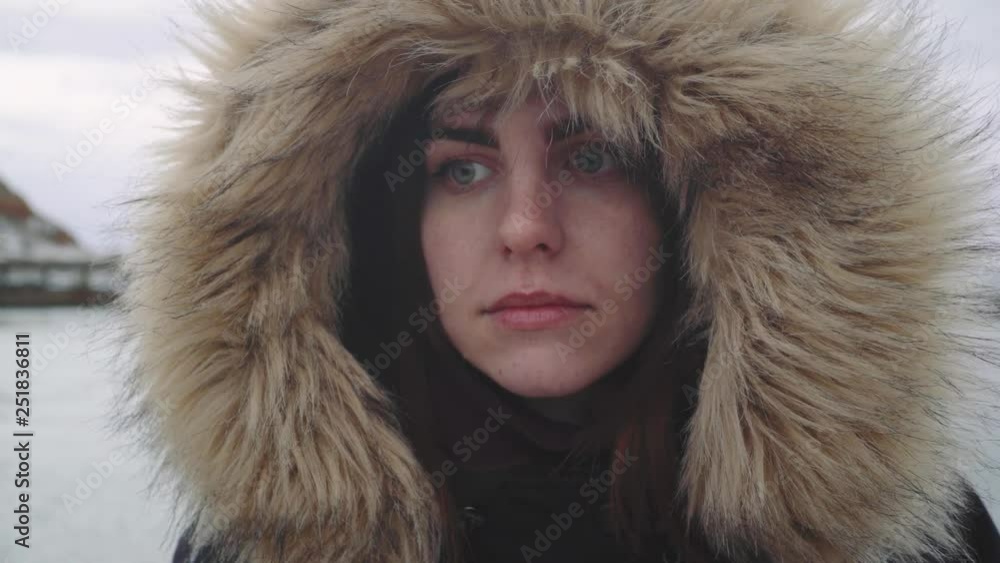 Closeup portrait of a young beautiful red-haired woman outdoors. Girl in a warm fluffy jacket Closeup portrait of a young beautiful red-haired woman outdoors. Girl in a warm fluffy jacket