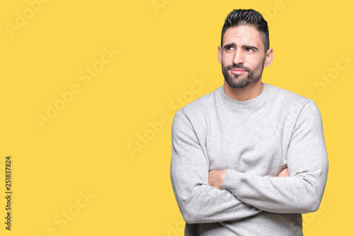 Young handsome man wearing sweatshirt over isolated background smiling looking side and staring away thinking. © Krakenimages.com