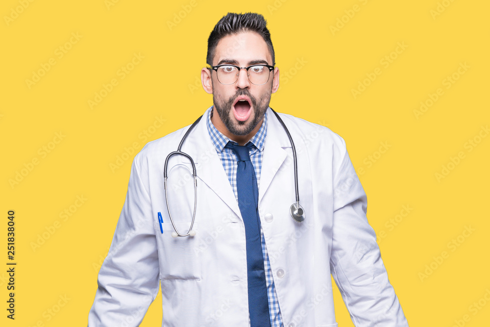 Handsome young doctor man over isolated background In shock face, looking skeptical and sarcastic, surprised with open mouth Handsome young doctor man over isolated background In shock face, looking skeptical and sarcastic, surprised with open mouth