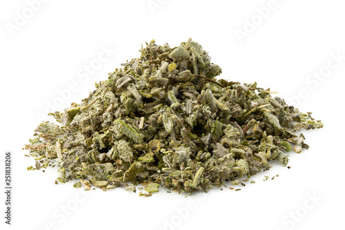 A pile of dried rubbed sage isolated on white.