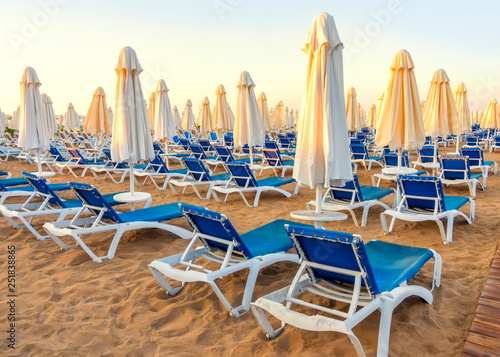 sandy beach to sea with sun beds and folded umbrellas, Turkey, Side resort © Alisa