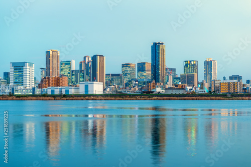 beautiful sunset landscape of Osaka city with modern buildings and river, Japan, panorama