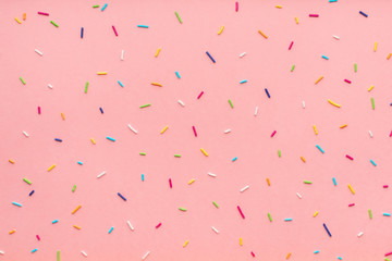 trendy pattern of colorful sprinkles for background of design banner, poster, flyer, card, postcard, cover, brochure over pink