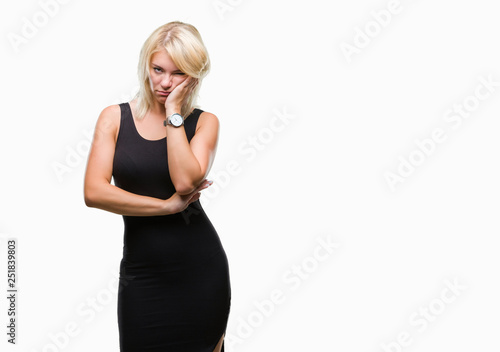 Young beautiful blonde attractive woman wearing elegant dress over isolated background thinking looking tired and bored with depression problems with crossed arms. © Krakenimages.com