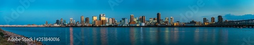 beautiful landscape of Osaka city with modern buildings and river, Japan, sunset, panorama
