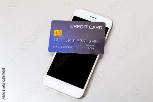 credit card put on mobile phone for preparing to pay online shopping