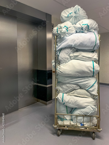 Collected laundry bags in the hospital are transported in a transport box. Concept: Health and hygiene