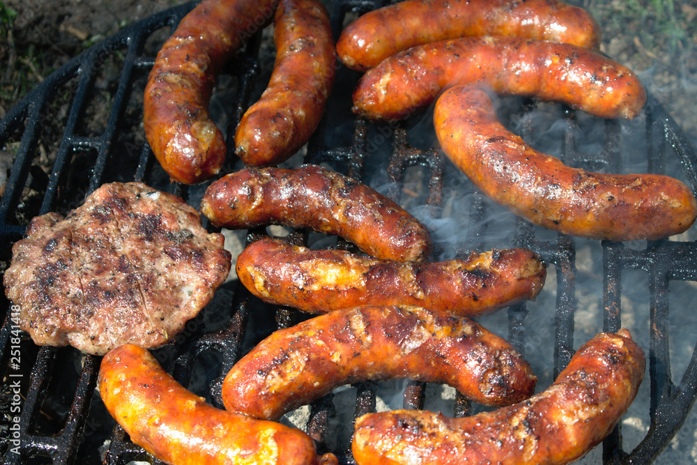 Sausages and hamburger patties on the BBQ Sausages and hamburger patties on the BBQ