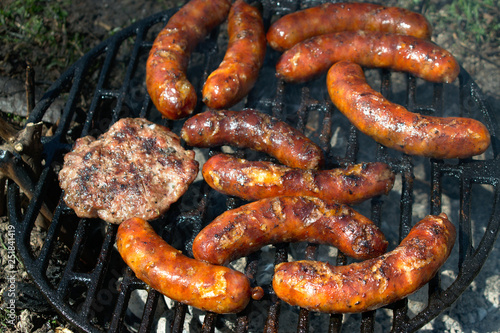 Sausages and hamburger patties on the BBQ