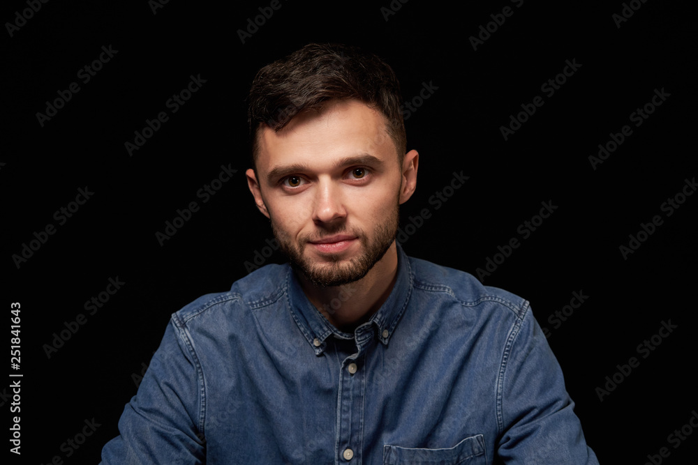 Handsome man in denim shirt looking at camera smiling Handsome man in denim shirt looking at camera smiling