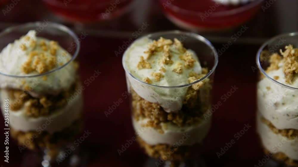 closeup panorama on three banana mousse dessert in round plastic glasses closeup panorama on three banana mousse dessert in round plastic glasses