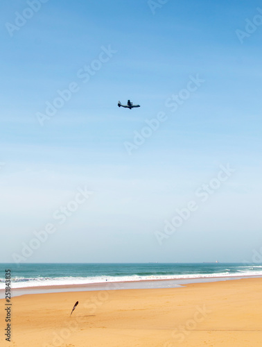 afternoon military aircraft flies over the ocean