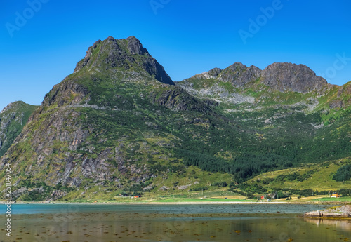 Norwegian fjord landscape near Moskenes in the heart of Lofoten, Norway. Beautiful mountain scenery in summer