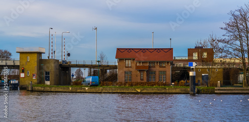 Dutch bungalow at the water side, with view on the molenaarsbrug, city architecture of Alpehn aan den Rijn, The netherlands photo