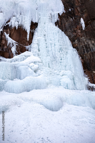 Frozen ice on rocks from a waterfall in the mountains