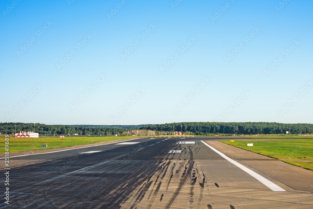 Runway with traces of rubber wheels of the aircraft free for takeoffs and landings at the airport