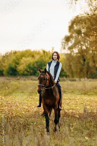 Beautiful girl riding a horse on autumn field © matilda553