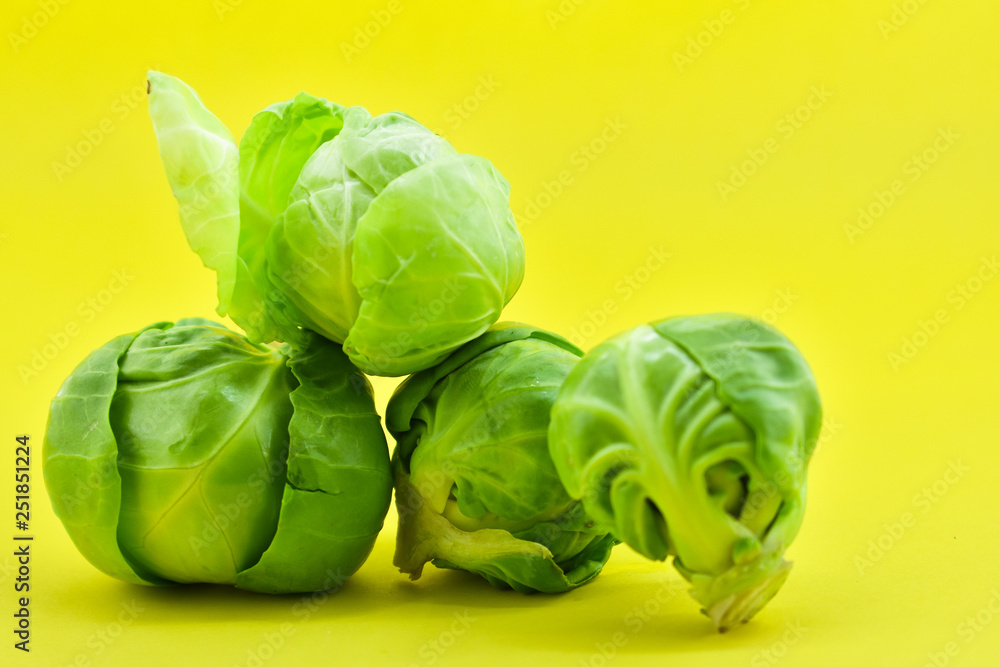Brussels sprouts on yellow background Brussels sprouts on yellow background