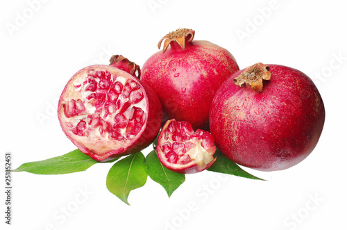 Pomegranate fruit with leaves on a white background.