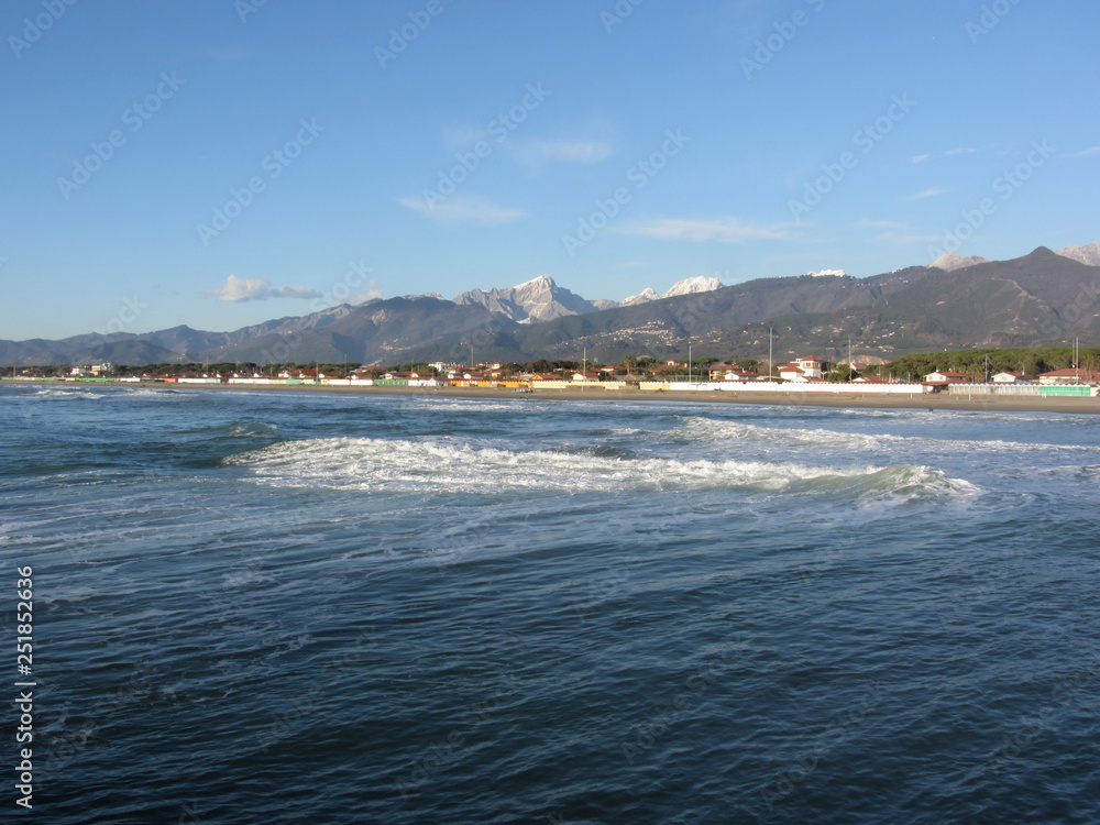 Panoramic view of Forte dei marmi coast with Apuan alps in background in winter . Tuscany, Italy