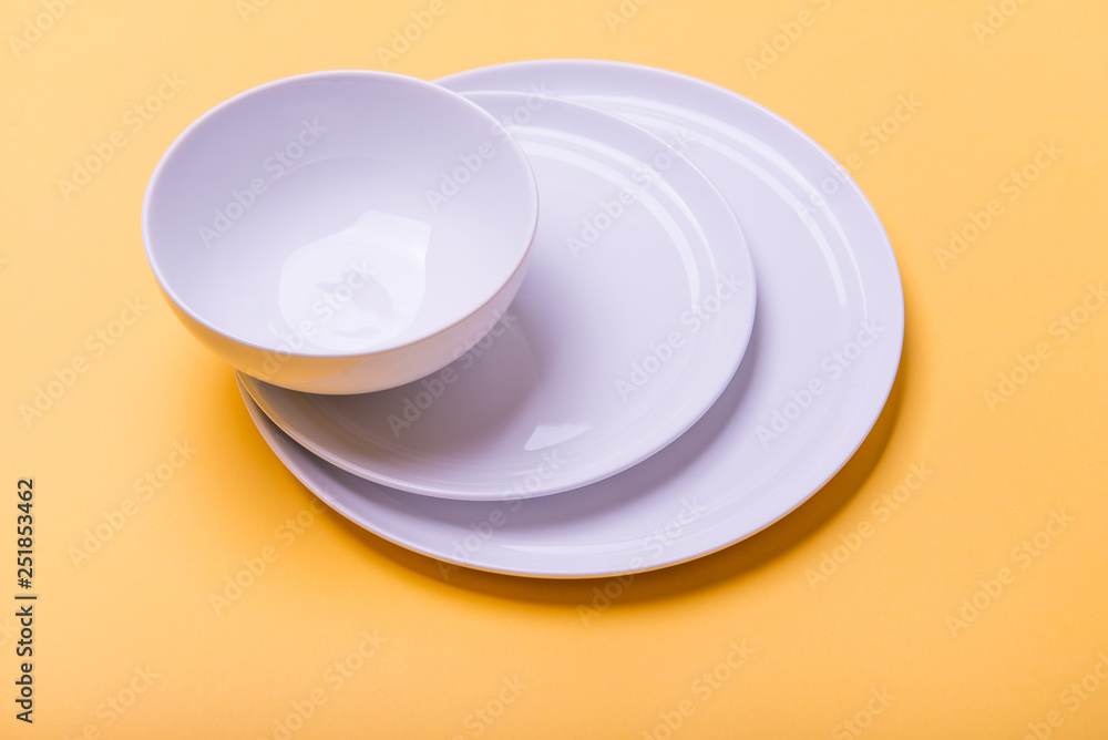 Plates and Bowl on Yellow Background Plates and Bowl on Yellow Background