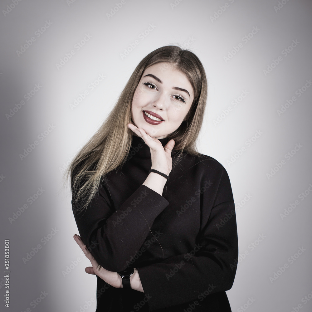 portrait of a young girl in a black dress on a light background in the studio portrait of a young girl in a black dress on a light background in the studio
