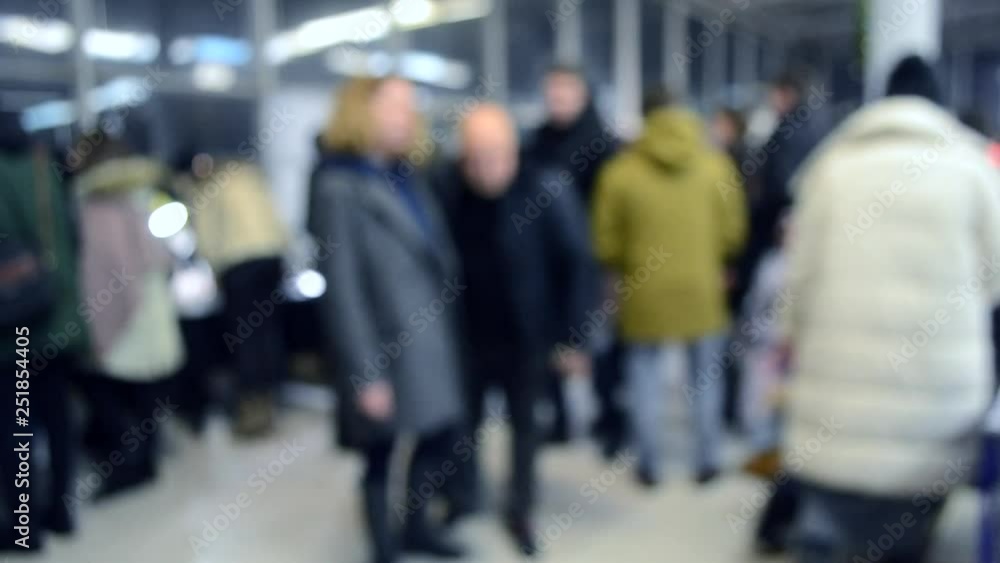 Many people walk inside the mall or store with illumination. Many people walk inside the mall or store with illumination.