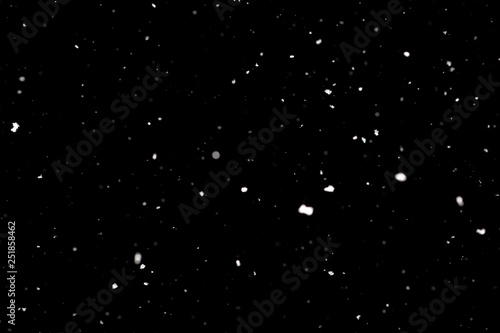 Snowstorm texture. Bokeh lights on black background  shot of flying snowflakes in the air