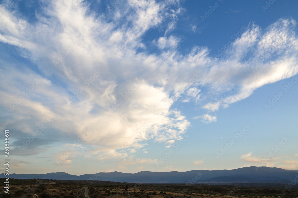 clouds in the blue sky over the mountains clouds in the blue sky over the mountains
