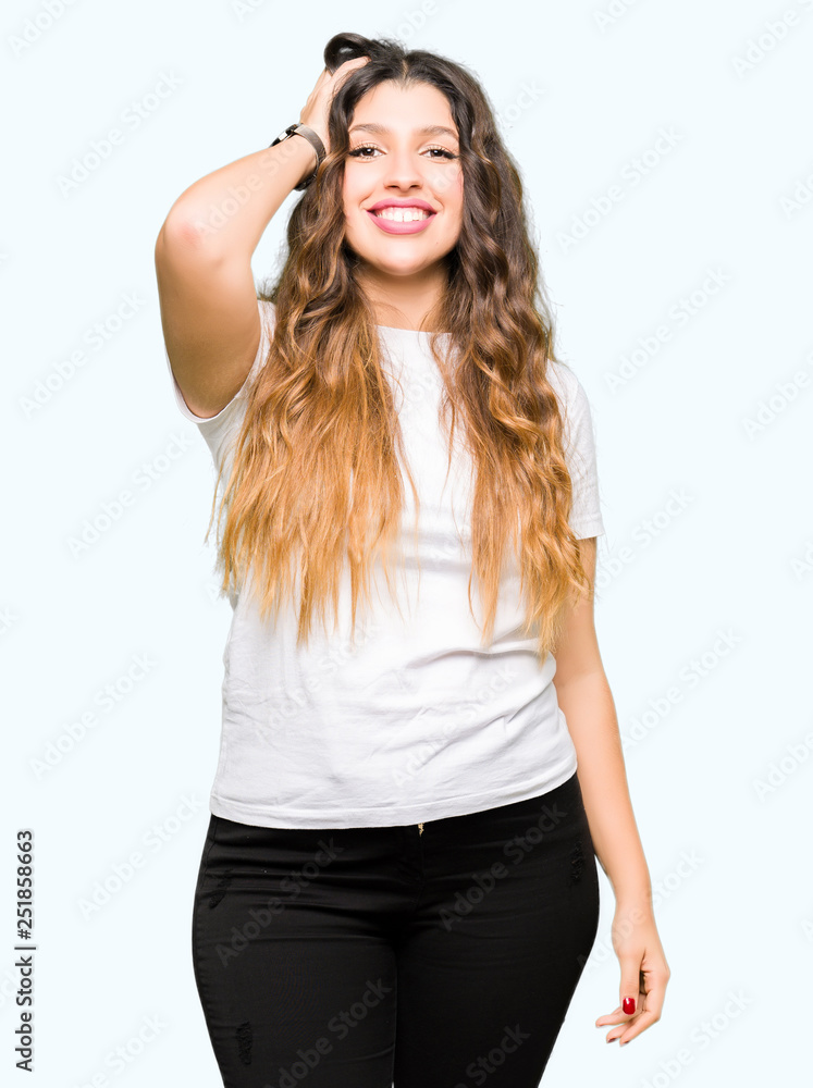 Young beautiful woman wearing casual white t-shirt Smiling confident touching hair with hand up gesture, posing attractive Young beautiful woman wearing casual white t-shirt Smiling confident touching hair with hand up gesture, posing attractive