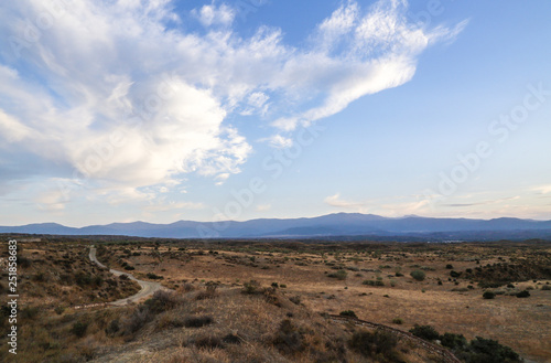 steppe desert landscape with blue sky and clouds