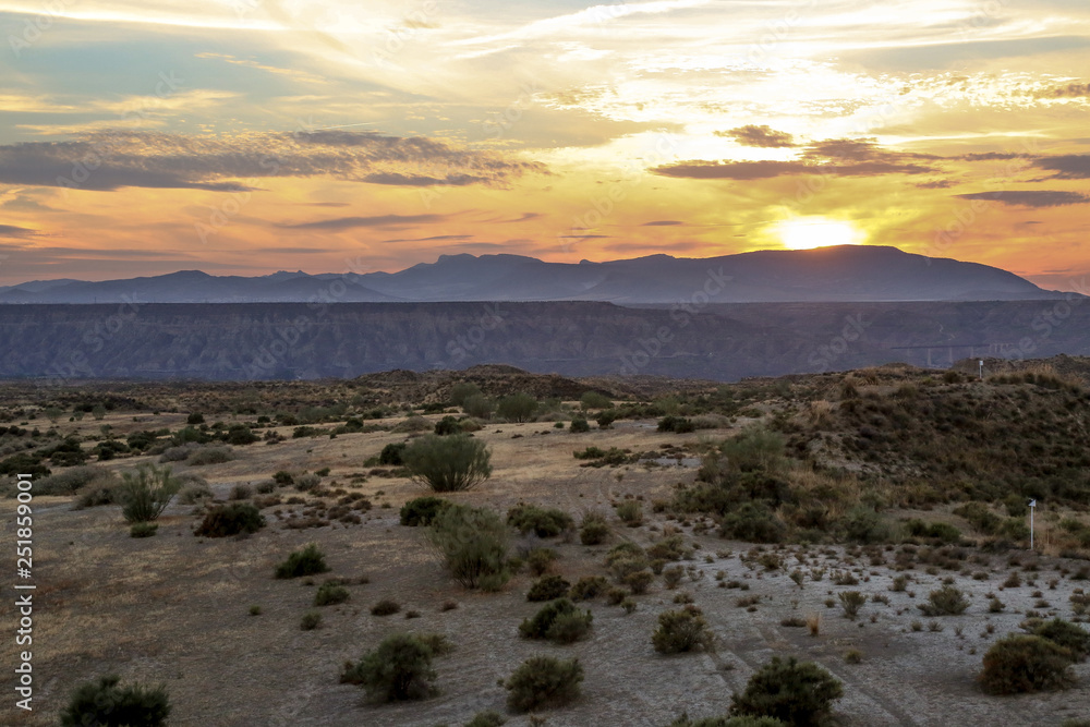 sunset over the mountains of a steppe grassland landscape sunset over the mountains of a steppe grassland landscape