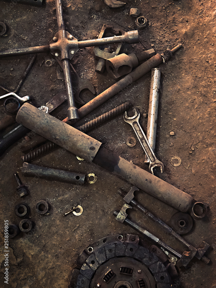 old parts and tools on the workshop floor old parts and tools on the workshop floor