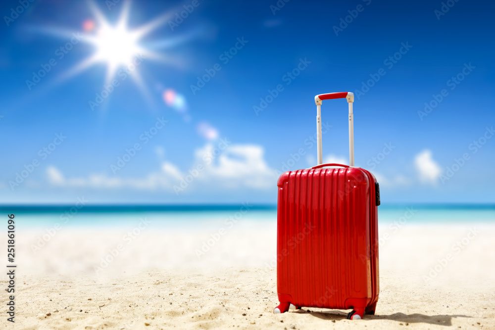Summer suitcase on beach and sea landscape Summer suitcase on beach and sea landscape